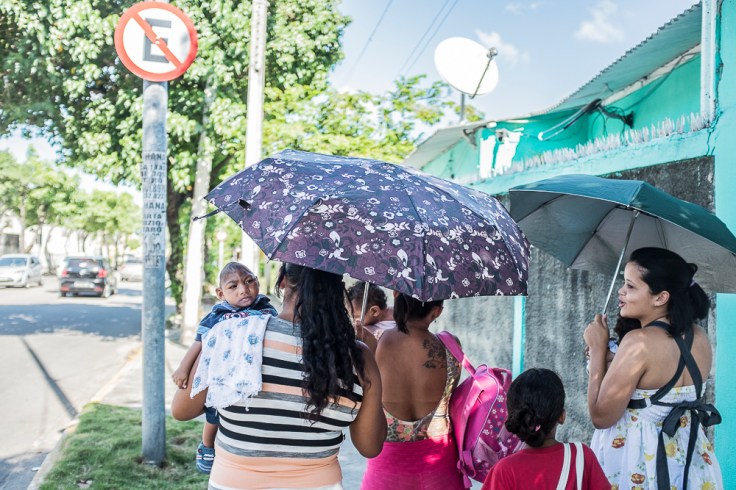 A group of mothers with their infants with microcephaly walking