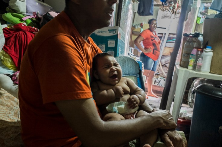 Paulo (49), Maria (20) and their daughter with microcephaly Eduarda Vitoria (5 months) inside their house, a shelter inside the slum of Santa Luzia in Recife, Pernambuco. Both of them are unemployed and extremely poor
